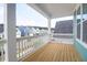 Charming balcony with wooden floors and white railings, offering serene neighborhood views at 1238 Homecoming Blvd Blvd, Ravenel, SC 29470