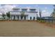 New construction home with a large yard, featuring white siding and a covered porch at 1238 Homecoming Blvd Blvd, Ravenel, SC 29470