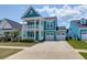Charming two-story home boasts a welcoming double porch and attached two-car garage at 1238 Homecoming Blvd Blvd, Ravenel, SC 29470