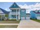 Charming two-story home boasts a welcoming double porch and attached two-car garage at 1238 Homecoming Blvd Blvd, Ravenel, SC 29470