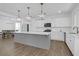 Spacious kitchen with stainless appliances, white cabinets, a large island, and contemporary pendant lighting at 1238 Homecoming Blvd Blvd, Ravenel, SC 29470