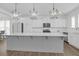 Bright kitchen featuring white cabinets, stainless steel appliances, a spacious island, and elegant pendant lights at 1238 Homecoming Blvd Blvd, Ravenel, SC 29470