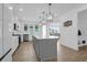 A modern, all-white kitchen features a large island, stainless appliances, and elegant pendant lighting at 1238 Homecoming Blvd Blvd, Ravenel, SC 29470