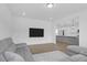 Open-concept living room showcasing a kitchen view, comfortable seating, and a modern entertainment area at 1238 Homecoming Blvd Blvd, Ravenel, SC 29470