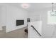 Bright loft area with a TV, mini fridge, and staircase with wood and metal railing at 1238 Homecoming Blvd Blvd, Ravenel, SC 29470
