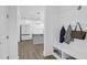 Mud room opening to a modern kitchen, featuring a storage bench and coat hooks at 1238 Homecoming Blvd Blvd, Ravenel, SC 29470