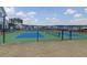 View of green and blue tennis courts in front of neighborhood houses on a sunny day at 1238 Homecoming Blvd Blvd, Ravenel, SC 29470