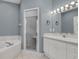 Bright bathroom featuring a glass enclosed shower, tub, and white vanity with and sinks at 1325 Moss Path, Mount Pleasant, SC 29464
