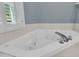 Bathroom with an elegant, all-white jacuzzi tub, perfect for relaxation at 1325 Moss Path, Mount Pleasant, SC 29464