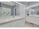 Bright bathroom with double vanity sinks and large mirror with vanity lighting at 1325 Moss Path, Mount Pleasant, SC 29464