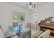 Bright dining room featuring a glass table, modern chandelier, and natural light from the nearby window at 1325 Moss Path, Mount Pleasant, SC 29464