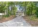 Beautiful home nestled in a wooded lot with a long drive leading up to the double porch at 1325 Moss Path, Mount Pleasant, SC 29464