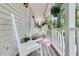 Cozy front porch with rocking chairs and flowers offering a relaxing outdoor space at 1325 Moss Path, Mount Pleasant, SC 29464