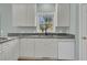 Bright kitchen featuring white cabinets, stainless steel appliances, and a view of the backyard at 1325 Moss Path, Mount Pleasant, SC 29464