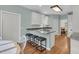 Kitchen with a breakfast bar, white cabinets, neutral walls, and access to an eat-in kitchen area at 1325 Moss Path, Mount Pleasant, SC 29464