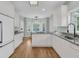 Charming kitchen with white cabinets, stainless steel appliances, and an adjacent breakfast nook with large windows at 1325 Moss Path, Mount Pleasant, SC 29464