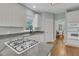 Well-lit kitchen featuring a modern gas cooktop, sink with faucet, and access to the breakfast area at 1325 Moss Path, Mount Pleasant, SC 29464