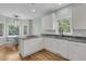 Eat-in kitchen with white cabinets, stainless steel appliances, and a breakfast area with ample natural light at 1325 Moss Path, Mount Pleasant, SC 29464
