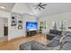 Bright living room with a large comfy couch, built-in shelving, and a modern ceiling fan at 1325 Moss Path, Mount Pleasant, SC 29464
