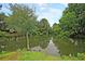 Scenic pond surrounded by lush greenery, trees, and beautiful reflections at 1325 Moss Path, Mount Pleasant, SC 29464