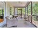 Screened porch with ceiling fan, outdoor furniture, and wooded views at 1325 Moss Path, Mount Pleasant, SC 29464
