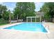 Inviting community pool with clear blue water, surrounded by lush greenery and lounge chairs at 1325 Moss Path, Mount Pleasant, SC 29464