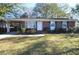 Charming brick home with a manicured lawn, covered carport, and inviting front entrance at 1340 Ashley Hall Rd, Charleston, SC 29407