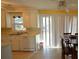 Bright kitchen with white cabinets, stainless steel sink, and sliding glass door for easy outdoor access at 1340 Ashley Hall Rd, Charleston, SC 29407