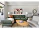 Living room featuring a plush green sofa, neutral armchair and modern decor at 14 Lockwood Dr # 1C, Charleston, SC 29401