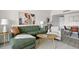 Comfortable living room with a green sofa, accent chair, and stylish decor and a cool, neutral color palette at 14 Lockwood Dr # 1C, Charleston, SC 29401