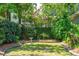 Lush backyard featuring mature trees and a decorative birdbath, creating a serene outdoor space at 15 Rutledge Ave, Charleston, SC 29401