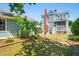 Spacious backyard featuring lush greenery and a beautiful two-story house, perfect for outdoor enjoyment at 15 Rutledge Ave, Charleston, SC 29401