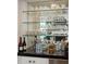 A bar area featuring glass shelves showcasing glassware and spirits at 15 Rutledge Ave, Charleston, SC 29401