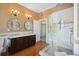Bright bathroom features a walk-in shower, wood floors, and a vanity with double sinks at 15 Rutledge Ave, Charleston, SC 29401