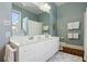 Bathroom featuring polka dot wallpaper, a double vanity, and white cabinets at 15 Rutledge Ave, Charleston, SC 29401