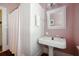 Charming bathroom with pedestal sink, walk-in shower with curtain, and vintage-style mirror at 15 Rutledge Ave, Charleston, SC 29401