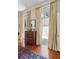 Bedroom featuring a wooden dresser with large windows and decorative curtains at 15 Rutledge Ave, Charleston, SC 29401