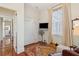 Cozy bedroom featuring a window with blinds, built-in closet, and hardwood floors at 15 Rutledge Ave, Charleston, SC 29401