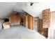 Large bonus room with wood paneled walls, neutral carpet, and exposed brick at 15 Rutledge Ave, Charleston, SC 29401