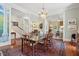 Bright dining room featuring chandelier lighting, hardwood floors, and decorative rug at 15 Rutledge Ave, Charleston, SC 29401