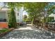 Long driveway with mature trees lining the side of the house, offering shade and curb appeal at 15 Rutledge Ave, Charleston, SC 29401