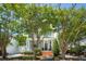 Charming two-story home with brick steps, a gray facade, and mature trees at 15 Rutledge Ave, Charleston, SC 29401