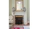 Decorative mantle with urns on top and a vintage style fireplace screen with antique brick in the hearth at 15 Rutledge Ave, Charleston, SC 29401