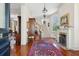 Grand foyer featuring gleaming hardwood floors, fireplace, elegant staircase, and classic architectural details at 15 Rutledge Ave, Charleston, SC 29401