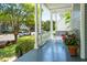 Cozy front porch features a porch swing, flower pot, and scenic neighborhood views at 15 Rutledge Ave, Charleston, SC 29401