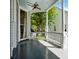 Charming front porch with ceiling fan and views of the neighborhood at 15 Rutledge Ave, Charleston, SC 29401