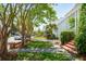 Well-manicured lawn and brick-lined flower beds enhance the curb appeal of this property at 15 Rutledge Ave, Charleston, SC 29401