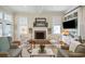 Bright living room featuring fireplace, hardwood floors, and decorative furnishings at 15 Rutledge Ave, Charleston, SC 29401