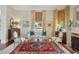 Comfortable living room with neutral tones, a fireplace, and large windows with patterned shades at 15 Rutledge Ave, Charleston, SC 29401