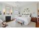 Charming main bedroom featuring a fireplace, neutral colors, and a large window at 15 Rutledge Ave, Charleston, SC 29401